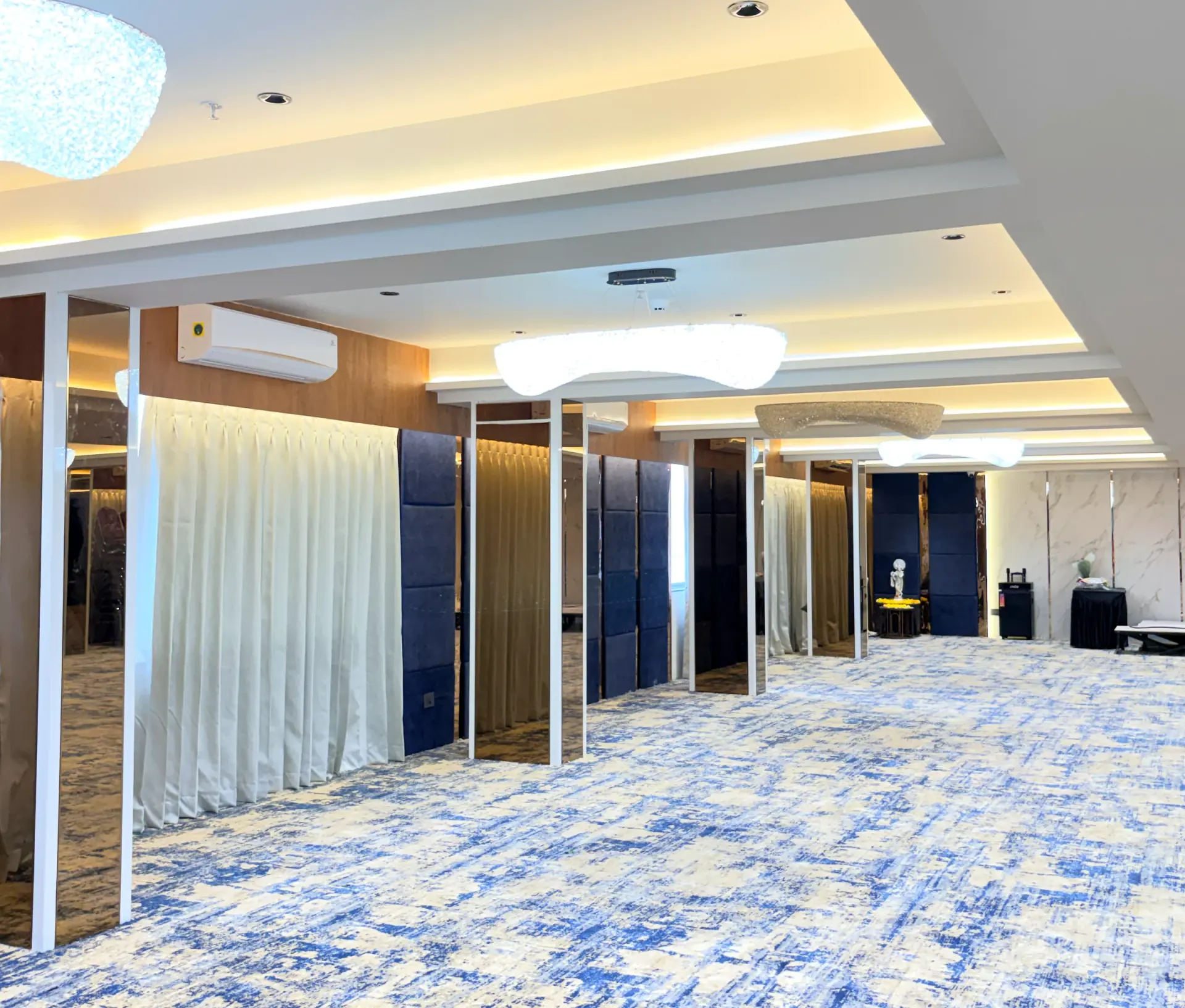 The banquet hall in a wider view, showing the columns and full-height curtains