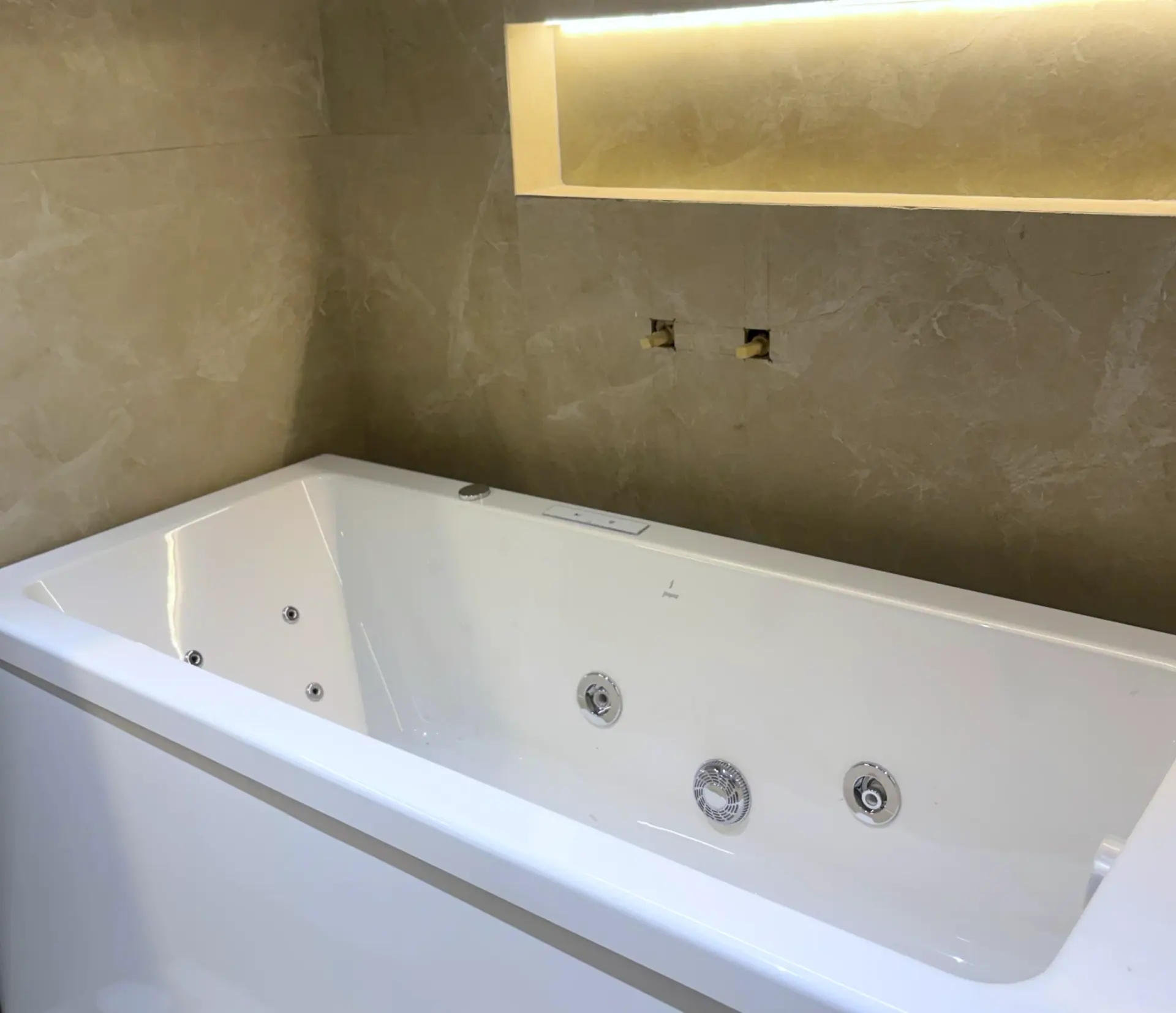 Whirlpool bath set into a stone surround