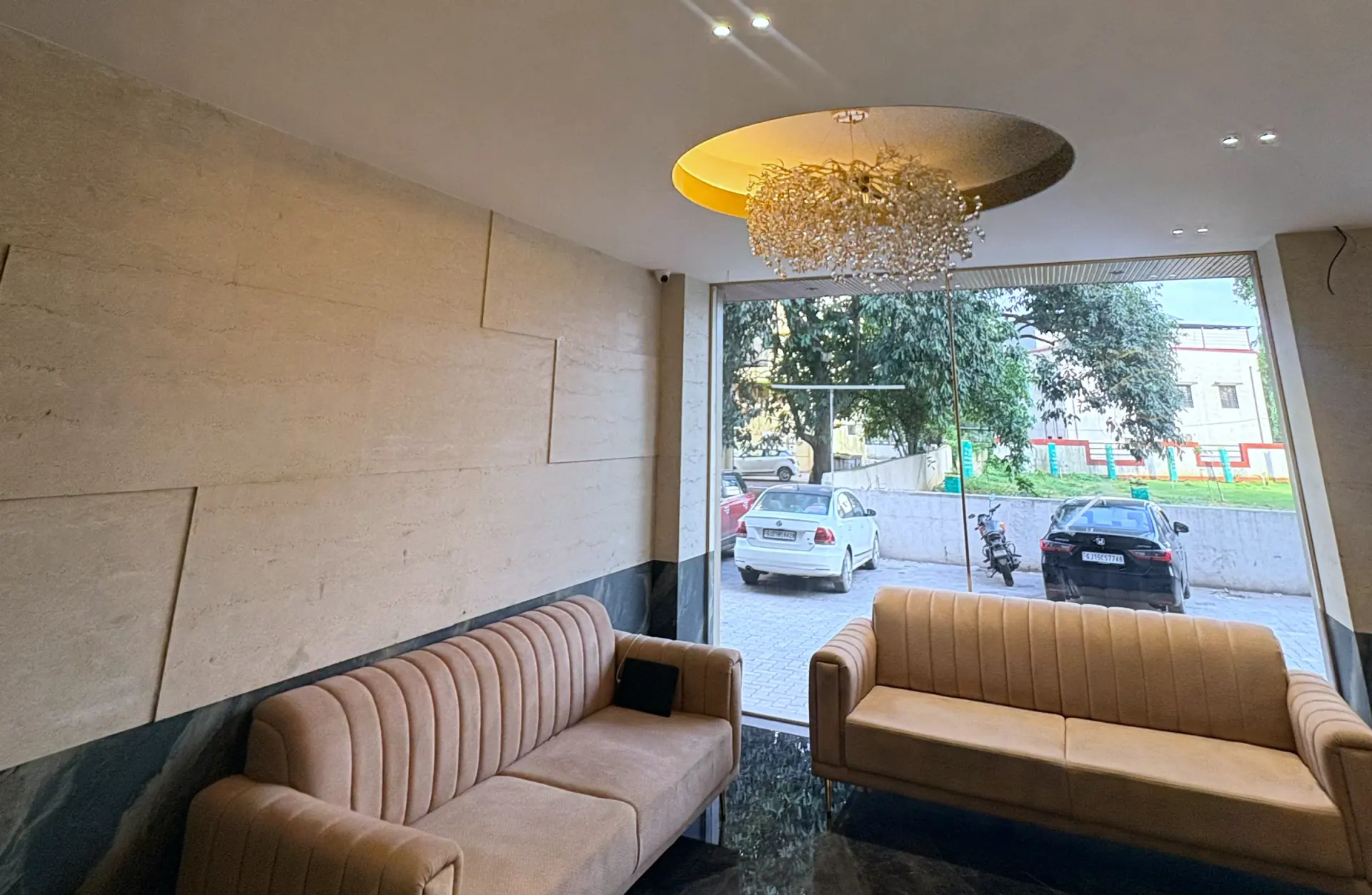 The lobby looking out to the street, banquette seating beneath a brass chandelier