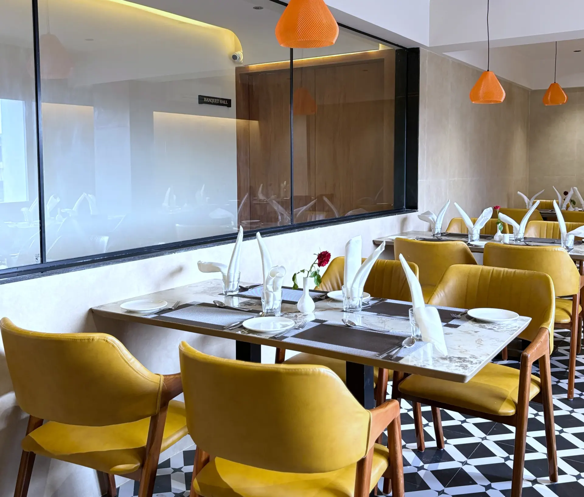 Restaurant banquette seating in mustard velvet against a stone wall